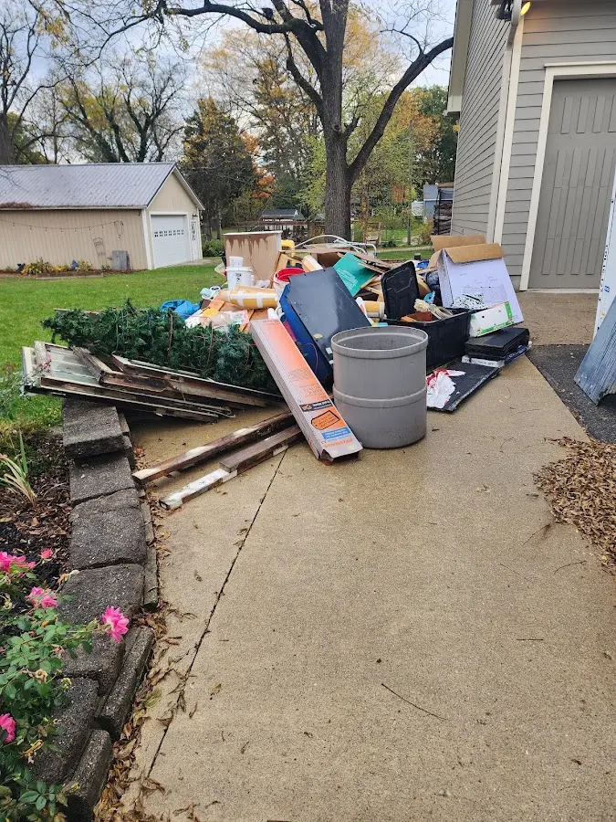 Dumpster being loaded with debris for Estate Cleanout Dumpster Rental in Forest Glen